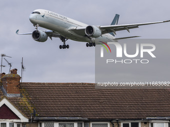 Cathay Pacific Airbus A350-900 passenger aircraft spotted flying over the houses in Myrtle Avenue before landing at London Heathrow Airport...