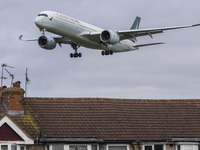 Cathay Pacific Airbus A350-900 passenger aircraft spotted flying over the houses in Myrtle Avenue before landing at London Heathrow Airport...