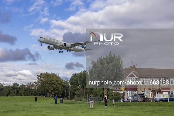 Cathay Pacific Airbus A350-900 passenger aircraft spotted flying over the houses in Myrtle Avenue before landing at London Heathrow Airport...