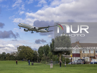 Cathay Pacific Airbus A350-900 passenger aircraft spotted flying over the houses in Myrtle Avenue before landing at London Heathrow Airport...