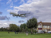 Cathay Pacific Airbus A350-900 passenger aircraft spotted flying over the houses in Myrtle Avenue before landing at London Heathrow Airport...