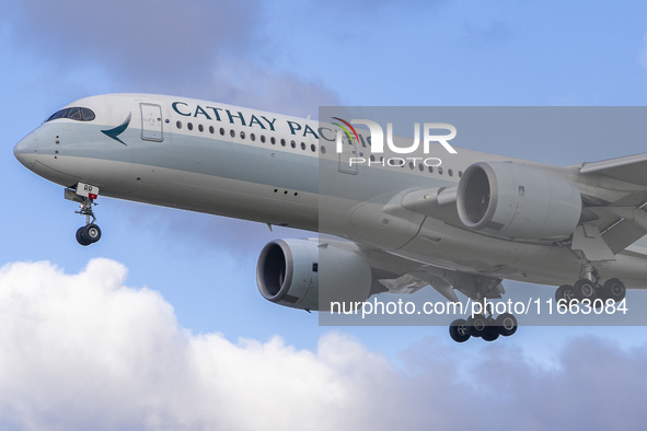 Cathay Pacific Airbus A350-900 passenger aircraft spotted flying over the houses in Myrtle Avenue before landing at London Heathrow Airport...