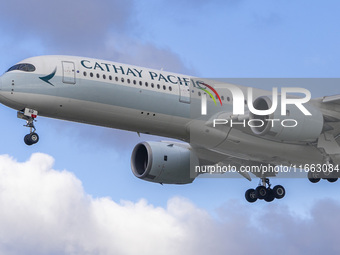 Cathay Pacific Airbus A350-900 passenger aircraft spotted flying over the houses in Myrtle Avenue before landing at London Heathrow Airport...