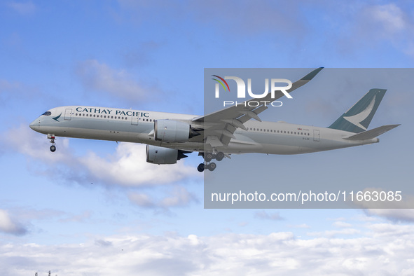 Cathay Pacific Airbus A350-900 passenger aircraft spotted flying over the houses in Myrtle Avenue before landing at London Heathrow Airport...