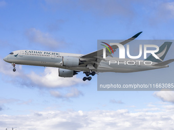 Cathay Pacific Airbus A350-900 passenger aircraft spotted flying over the houses in Myrtle Avenue before landing at London Heathrow Airport...