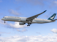 Cathay Pacific Airbus A350-900 passenger aircraft spotted flying over the houses in Myrtle Avenue before landing at London Heathrow Airport...