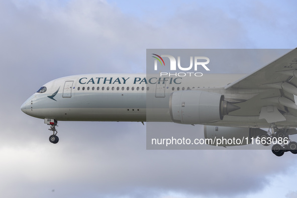 Cathay Pacific Airbus A350-900 passenger aircraft spotted flying over the houses in Myrtle Avenue before landing at London Heathrow Airport...