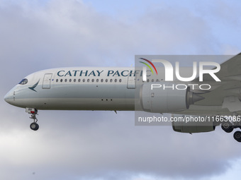 Cathay Pacific Airbus A350-900 passenger aircraft spotted flying over the houses in Myrtle Avenue before landing at London Heathrow Airport...