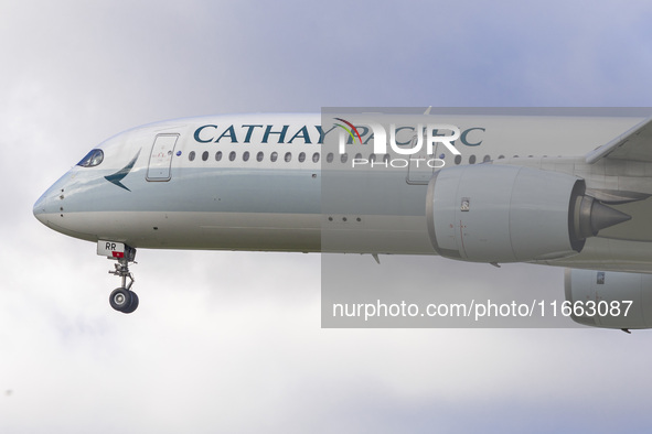 Cathay Pacific Airbus A350-900 passenger aircraft spotted flying over the houses in Myrtle Avenue before landing at London Heathrow Airport...