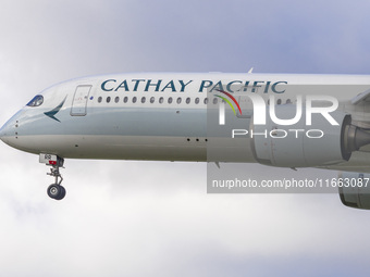 Cathay Pacific Airbus A350-900 passenger aircraft spotted flying over the houses in Myrtle Avenue before landing at London Heathrow Airport...