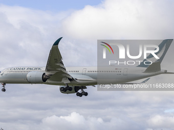 Cathay Pacific Airbus A350-900 passenger aircraft spotted flying over the houses in Myrtle Avenue before landing at London Heathrow Airport...