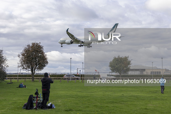 Cathay Pacific Airbus A350-900 passenger aircraft spotted flying over the houses in Myrtle Avenue before landing at London Heathrow Airport...