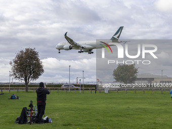 Cathay Pacific Airbus A350-900 passenger aircraft spotted flying over the houses in Myrtle Avenue before landing at London Heathrow Airport...