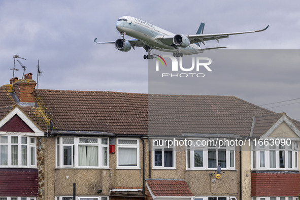 Cathay Pacific Airbus A350-900 passenger aircraft spotted flying over the houses in Myrtle Avenue before landing at London Heathrow Airport...