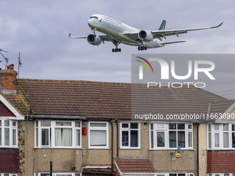 Cathay Pacific Airbus A350-900 passenger aircraft spotted flying over the houses in Myrtle Avenue before landing at London Heathrow Airport...