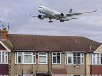 Cathay Pacific Airbus A350-900 passenger aircraft spotted flying over the houses in Myrtle Avenue before landing at London Heathrow Airport...