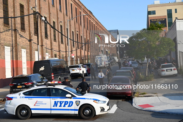 Authorities investigate the scene where a police officer dies by suicide in the Sunset Park section of Brooklyn, New York, United States, on...