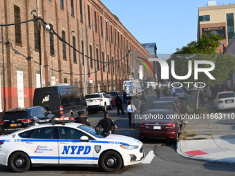 Authorities investigate the scene where a police officer dies by suicide in the Sunset Park section of Brooklyn, New York, United States, on...