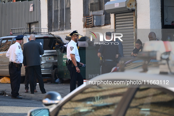 Authorities investigate the scene where a police officer dies by suicide in the Sunset Park section of Brooklyn, New York, United States, on...