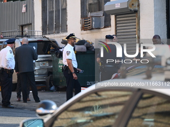 Authorities investigate the scene where a police officer dies by suicide in the Sunset Park section of Brooklyn, New York, United States, on...