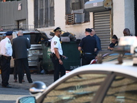 Authorities investigate the scene where a police officer dies by suicide in the Sunset Park section of Brooklyn, New York, United States, on...