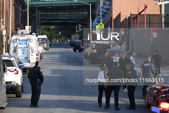 Authorities investigate the scene where a police officer dies by suicide in the Sunset Park section of Brooklyn, New York, United States, on...