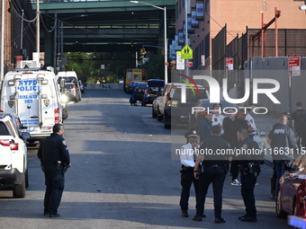 Authorities investigate the scene where a police officer dies by suicide in the Sunset Park section of Brooklyn, New York, United States, on...