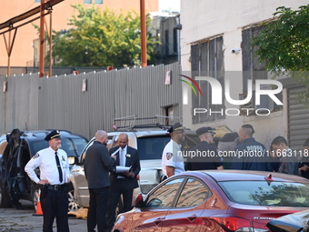 Authorities investigate the scene where a police officer dies by suicide in the Sunset Park section of Brooklyn, New York, United States, on...