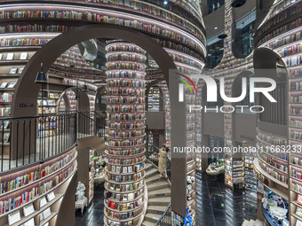 Visitors read books at Zhongshuge Bookstore in Chengdu, China, on October 13, 2024. (