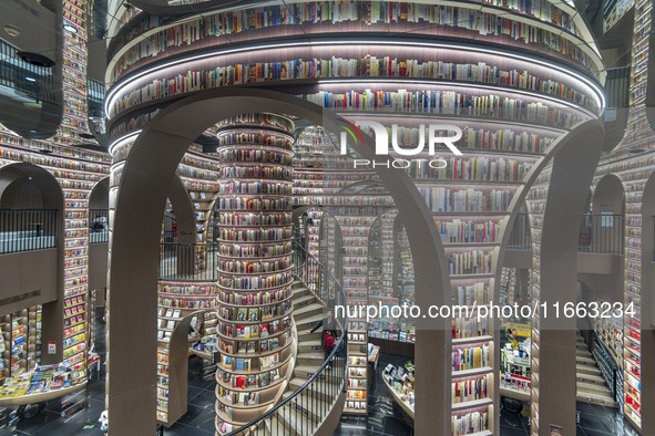 Visitors read books at Zhongshuge Bookstore in Chengdu, China, on October 13, 2024. 