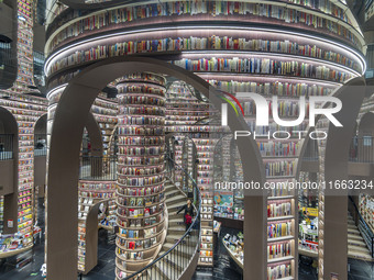 Visitors read books at Zhongshuge Bookstore in Chengdu, China, on October 13, 2024. (