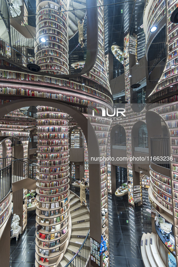 Visitors read books at Zhongshuge Bookstore in Chengdu, China, on October 13, 2024. 