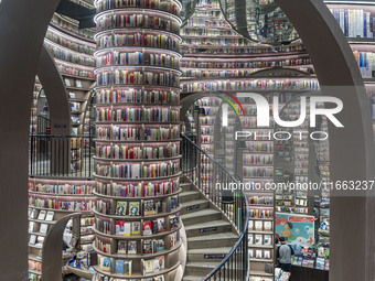 Visitors read books at Zhongshuge Bookstore in Chengdu, China, on October 13, 2024. (