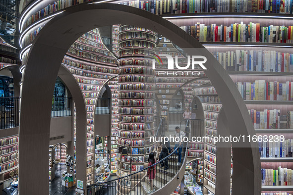 Visitors read books at Zhongshuge Bookstore in Chengdu, China, on October 13, 2024. 