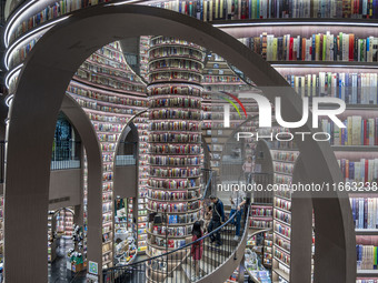 Visitors read books at Zhongshuge Bookstore in Chengdu, China, on October 13, 2024. (