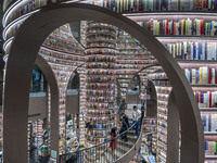 Visitors read books at Zhongshuge Bookstore in Chengdu, China, on October 13, 2024. (