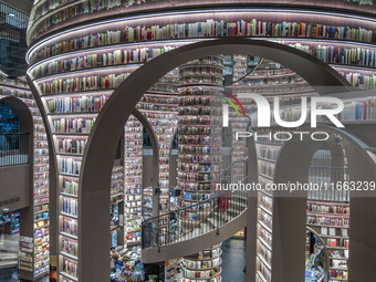 Visitors read books at Zhongshuge Bookstore in Chengdu, China, on October 13, 2024. (