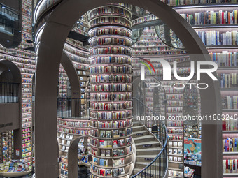 Visitors read books at Zhongshuge Bookstore in Chengdu, China, on October 13, 2024. (