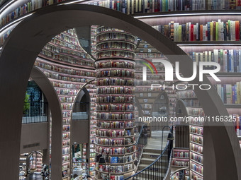 Visitors read books at Zhongshuge Bookstore in Chengdu, China, on October 13, 2024. (