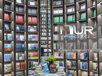 Visitors read books at Zhongshuge Bookstore in Chengdu, China, on October 13, 2024. (