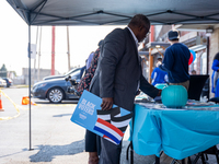 A man picks out Harris-Walz campaign posters at a campaign event in Philadelphia, Pennsylvania, United States, on October 13, 2024. (