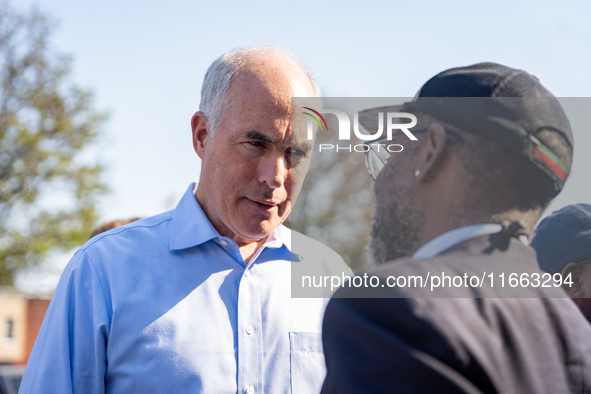 Sen. Bob Casey (D-PA) speaks to a man outside a campaign rally in Philadelphia, Pennsylvania, United States, on October 13, 2024. 