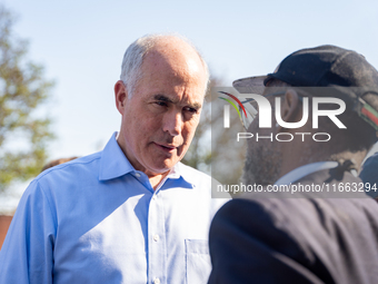 Sen. Bob Casey (D-PA) speaks to a man outside a campaign rally in Philadelphia, Pennsylvania, United States, on October 13, 2024. (