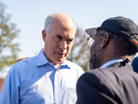 Sen. Bob Casey (D-PA) speaks to a man outside a campaign rally in Philadelphia, Pennsylvania, United States, on October 13, 2024. (