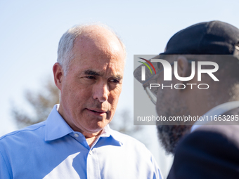 Sen. Bob Casey (D-PA) speaks to a man outside a campaign rally in Philadelphia, Pennsylvania, United States, on October 13, 2024. (