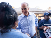 Sen. Bob Casey (D-PA) speaks to a woman outside a campaign rally in Philadelphia, Pennsylvania, United States, on October 13, 2024. (