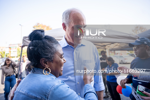 Sen. Bob Casey (D-PA) speaks to a woman outside a campaign rally in Philadelphia, Pennsylvania, United States, on October 13, 2024. 