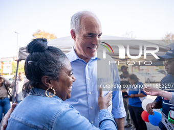 Sen. Bob Casey (D-PA) speaks to a woman outside a campaign rally in Philadelphia, Pennsylvania, United States, on October 13, 2024. (