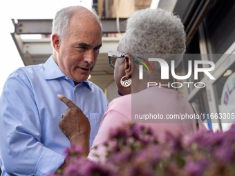 Sen. Bob Casey (D-PA) speaks to a woman outside a campaign rally in Philadelphia, Pennsylvania, United States, on October 13, 2024. (