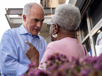 Sen. Bob Casey (D-PA) speaks to a woman outside a campaign rally in Philadelphia, Pennsylvania, United States, on October 13, 2024. (